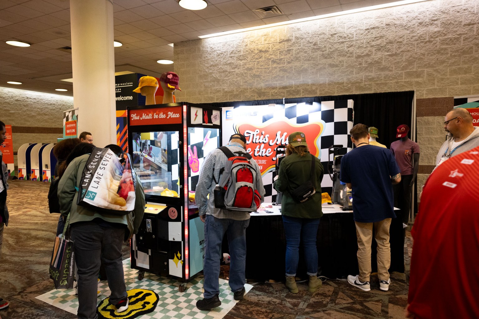 Stahls' welcomed Impressions Expo Atlantic City attendees with a live heat press activation with an arcade theme. Participants had fun playing the claw machine to win a free hat with Stahls’ Ultra Color Max DTF transfers.