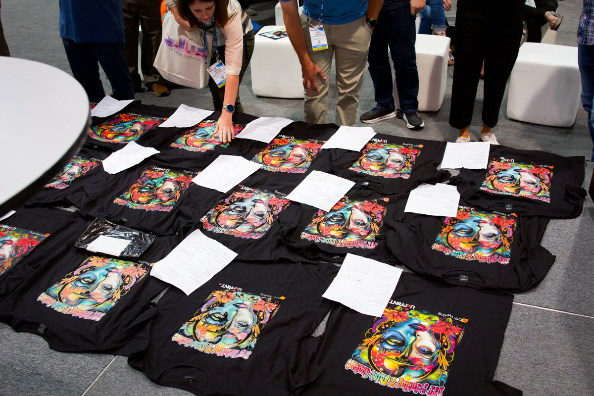 Attendees perused all of the submitted printed T-shirts. Every single T-shirt was different.