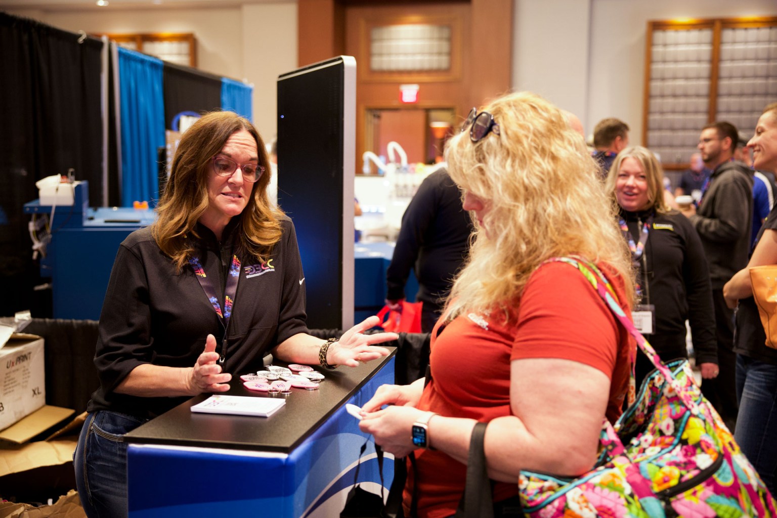 Denise Bayer of DB Custom Creations met with a potential customer on the show floor. DB Custom Creations offers wholesale custom DTF transfer printing. You can learn more about Denise and her journey with DTF during her episode of the DTF Printing Podcast.