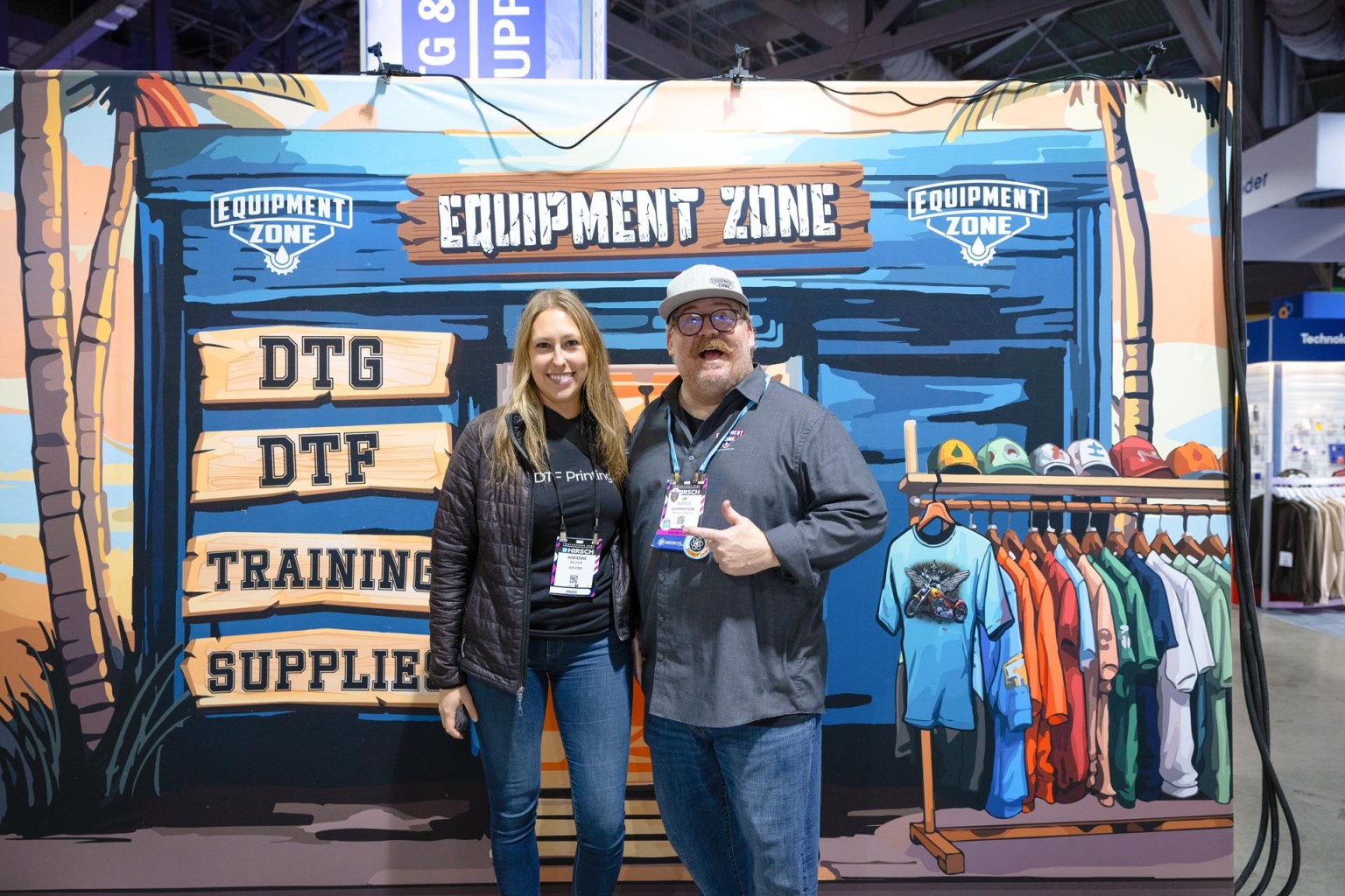 Jay Busselle of Equipment Zone and DTF Printing Editor-in-Chief Adrienne Palmer hang at the EZ booth. Click the next slide to see the gang sheet printed via Equipment Zone’s EZ-Jet Pro 24 direct-to-film printer.